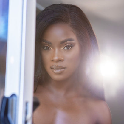 Ana Foxx with long, straight brown hair looking into the camera.